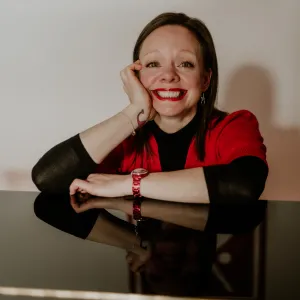 Taylor sitting at piano